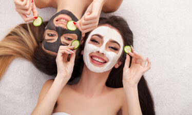 two women with spa face masks