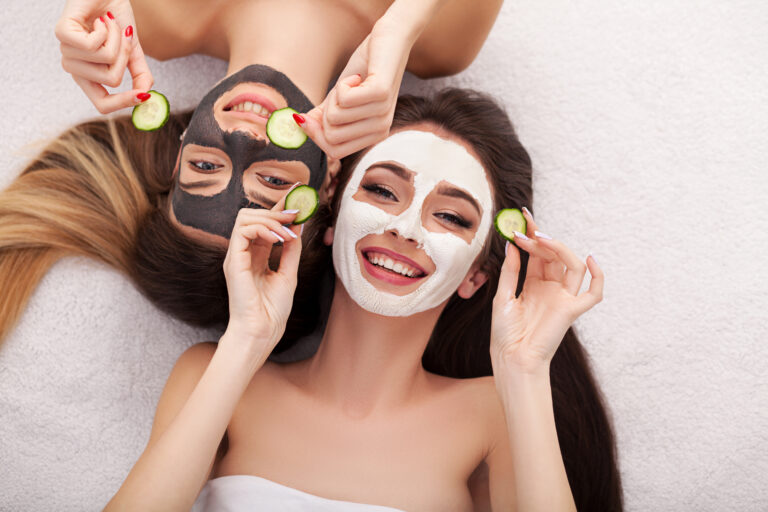 two women with spa face masks
